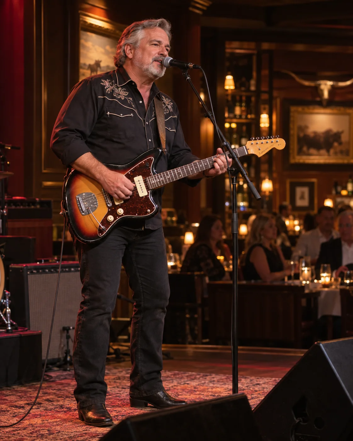 Robert performing lead vocals and rhythm guitar with a sunburst Fender Jazzmaster at a restaurant stage
